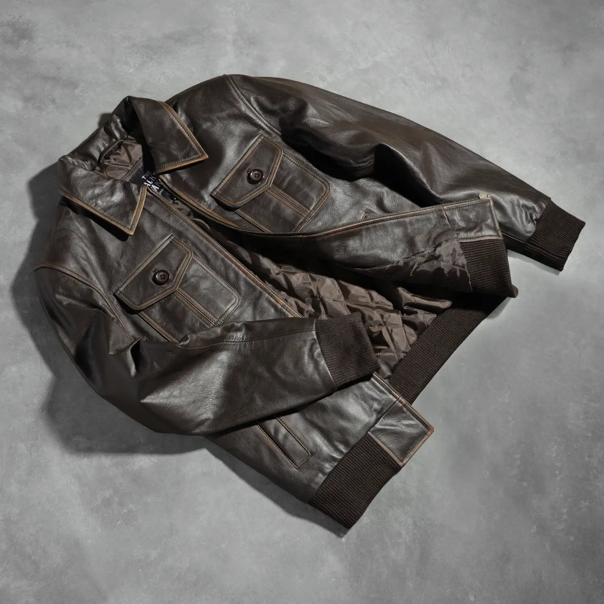
Knit Rib & Hem Craftsmanship Construction Detail on Men's Aaron Distressed Brown Leather Bomber Jacket