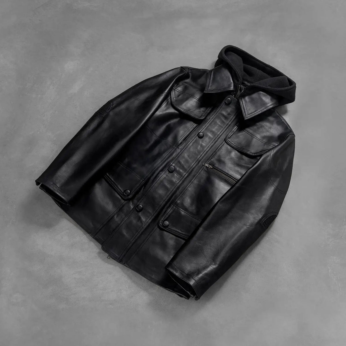
Styled Fit Perspective of Men's Moulder Hooded Black Leather Jacket on Model - Natural Daylight Drape